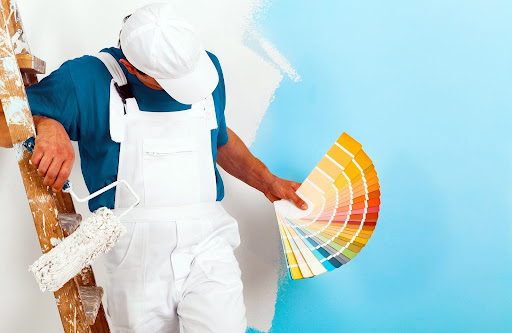 man holding different kind of paint colors | types of paint finishes