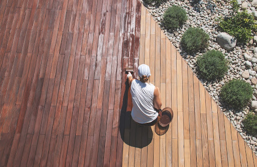man staining floor | staining wood
