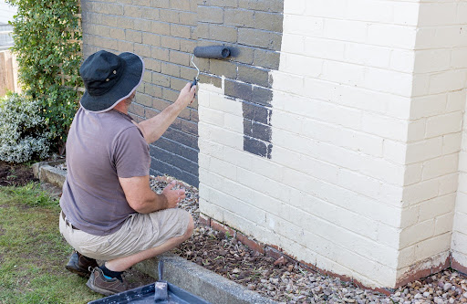 man painting bricks | painted brick walls
