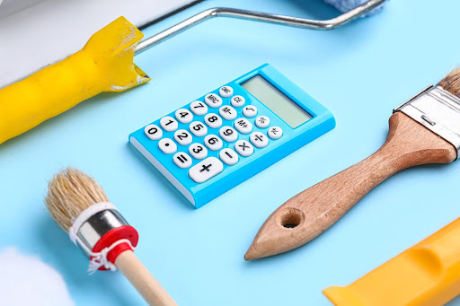 calculator between brushes | cost to paint interior of a house